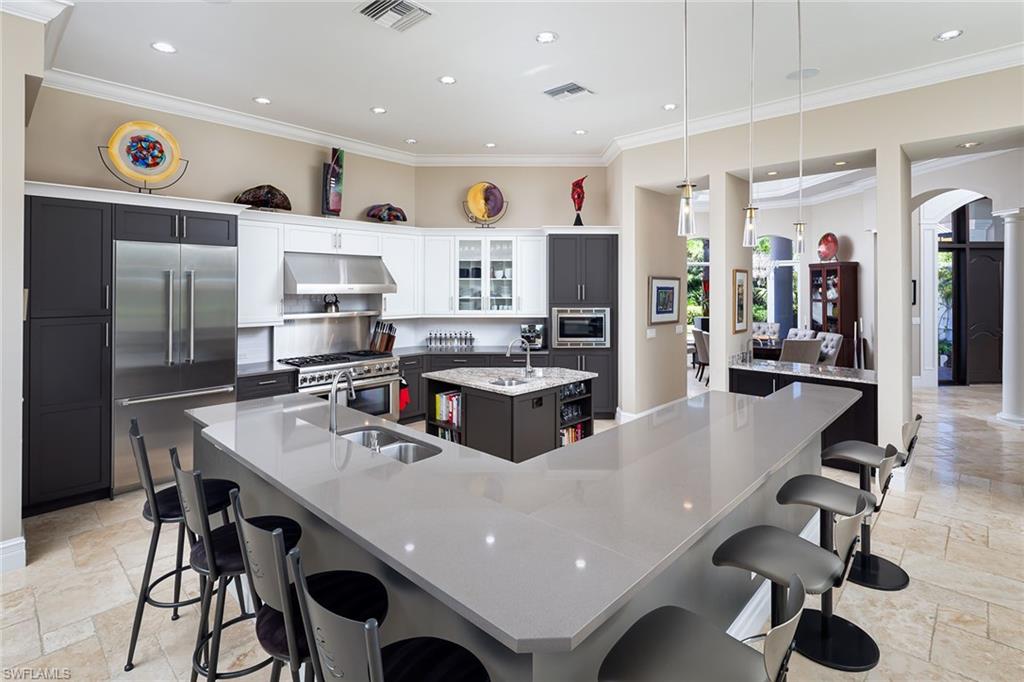 11617 Useppa Court Naples, FL 34110 - Photo 10 of 50 a large kitchen with a table and chairs