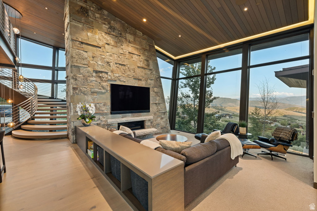 8544 North Promontory Ranch Road Park City, UT 84098 - Photo 13 of 36 Living area with expansive windows, a fireplace, a vaulted wood ceiling, and recessed lighting