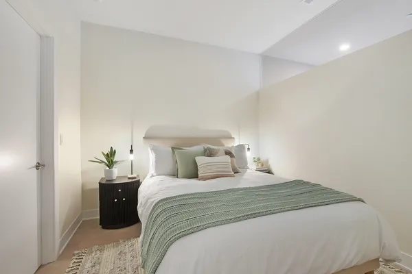 a bedroom with a bed and a lamp