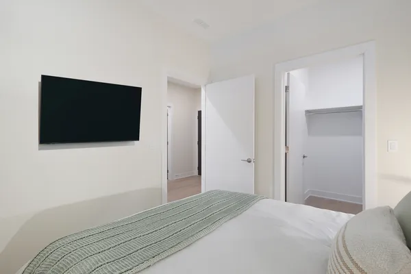 a bedroom with a bed and a flat screen tv