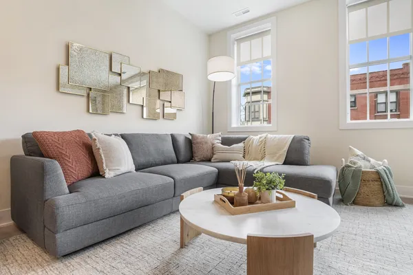 a living room with furniture and painting on the wall