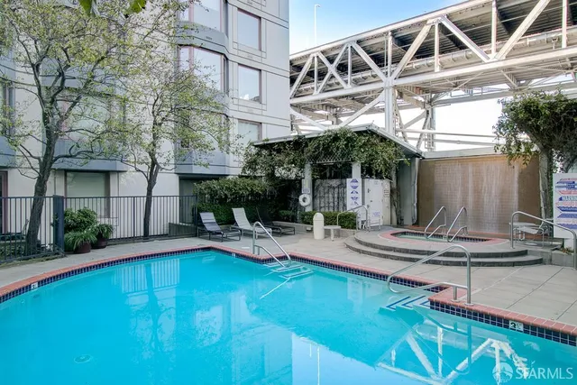a view of a house with pool and sitting area