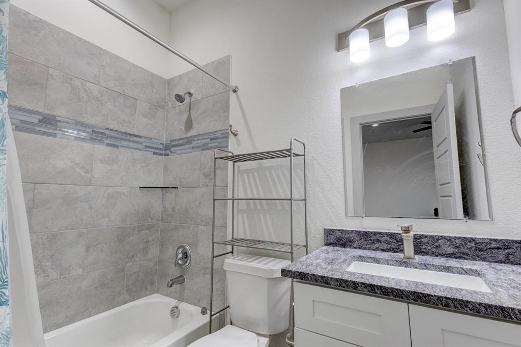 6043 Rivendell Drive Frisco, TX 75035 - Photo 10 of 38 a bathroom with a granite countertop sink a toilet and shower