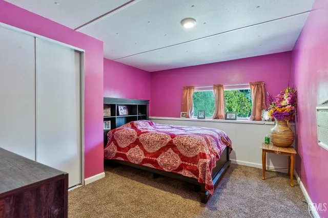 a bathroom with a sink flowers and a mirror