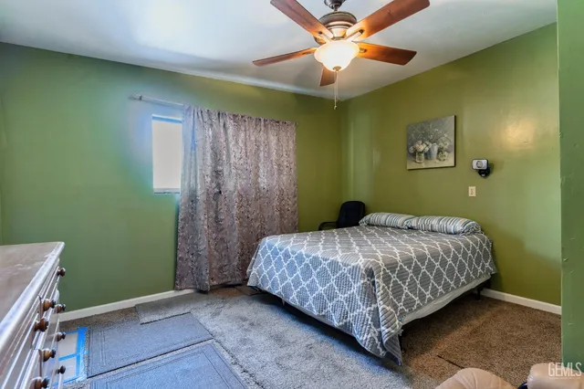 a bedroom with a bed and a dresser