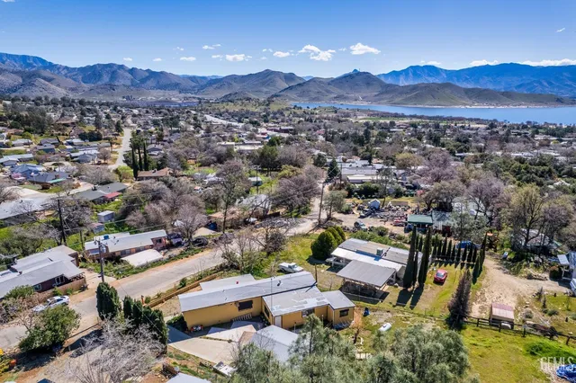 an aerial view of residential house with an outdoor space and mountain view