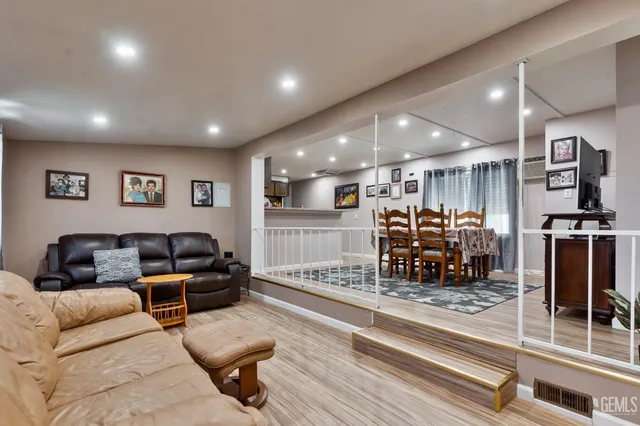 a living room with furniture and kitchen view