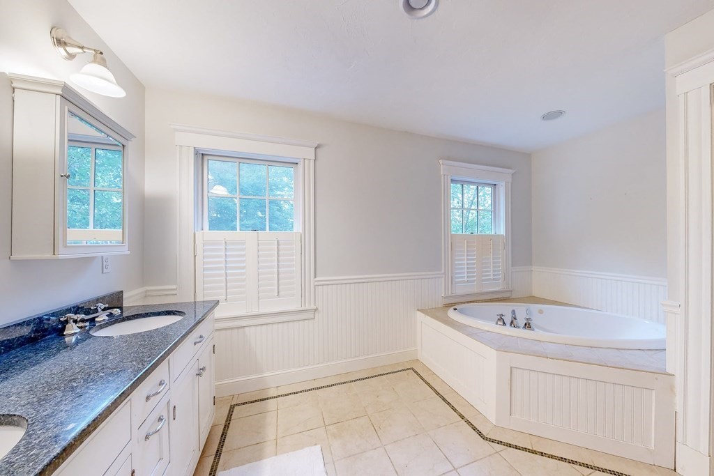 17 Broken Tree Road Medway, MA 02053 - Photo 28 of 40 a bathroom with a granite countertop tub a sink and a window
