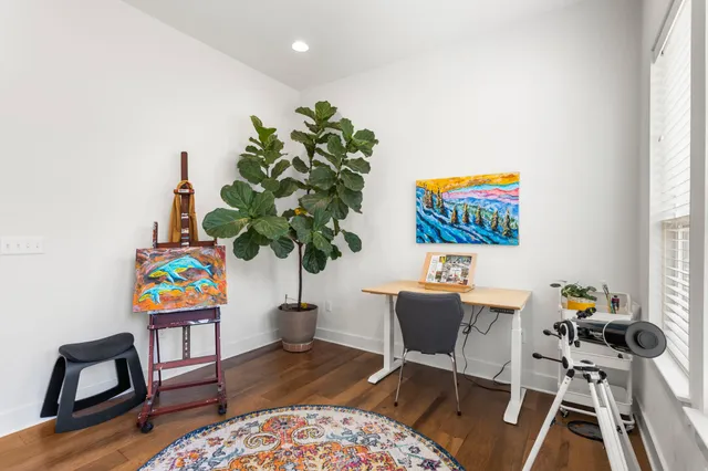 a view of a kitchen with cabinets and wooden floor