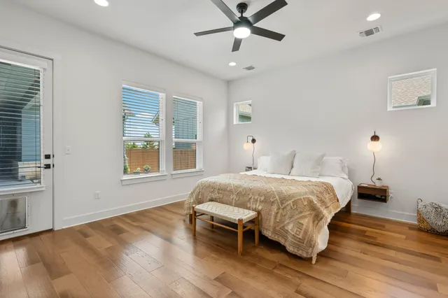 a bedroom with furniture and a flat screen tv