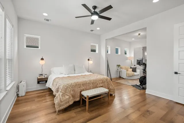 a bedroom with a bed and a chandelier