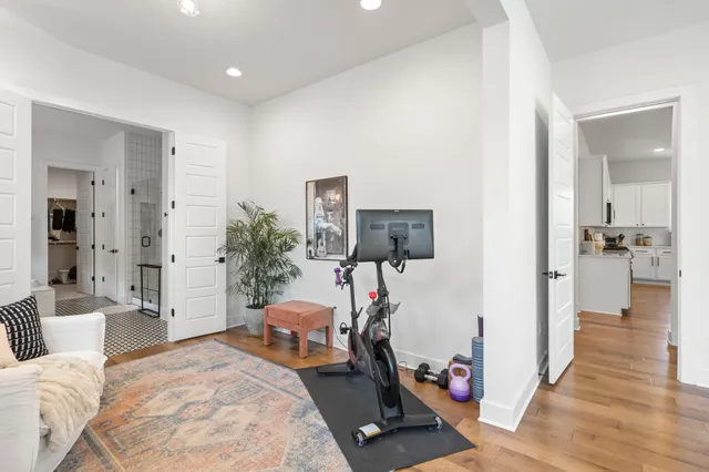 a bathroom with a sink a toilet a mirror and shower