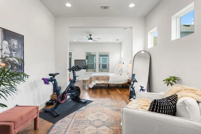 a living room with furniture and a mirror