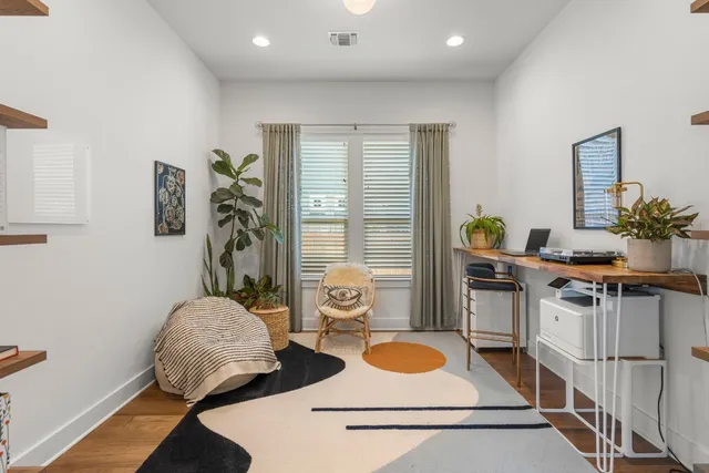 a living room with furniture and a potted plant