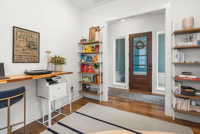 a room with furniture a rug and a book shelf