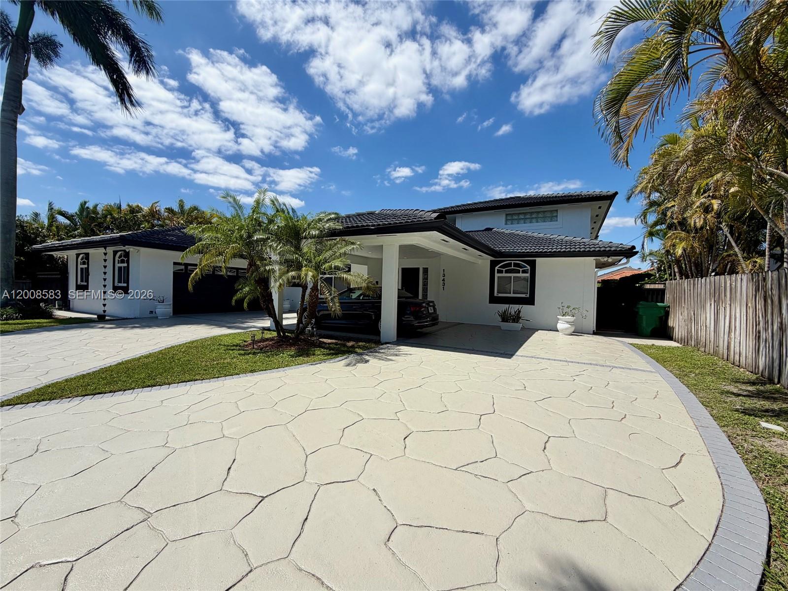 13431 Southwest 32nd Street Miami, FL 33165 - Photo 1 of 77 a front view of a house with a yard