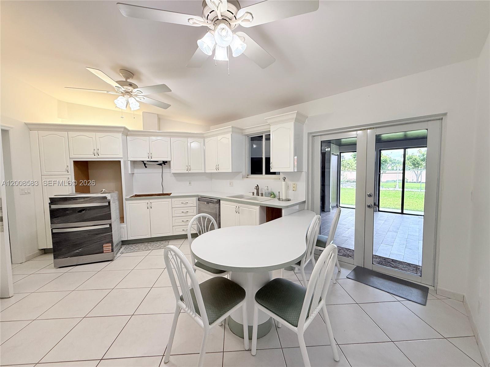 13431 Southwest 32nd Street Miami, FL 33165 - Photo 13 of 77 a kitchen with stainless steel appliances kitchen island granite countertop a stove a sink and a refrigerator