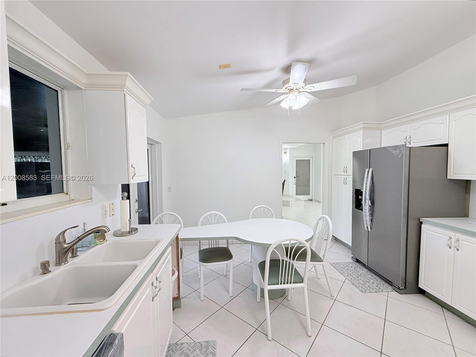 13431 Southwest 32nd Street Miami, FL 33165 - Photo 15 of 77 a kitchen with granite countertop a sink appliances and cabinets