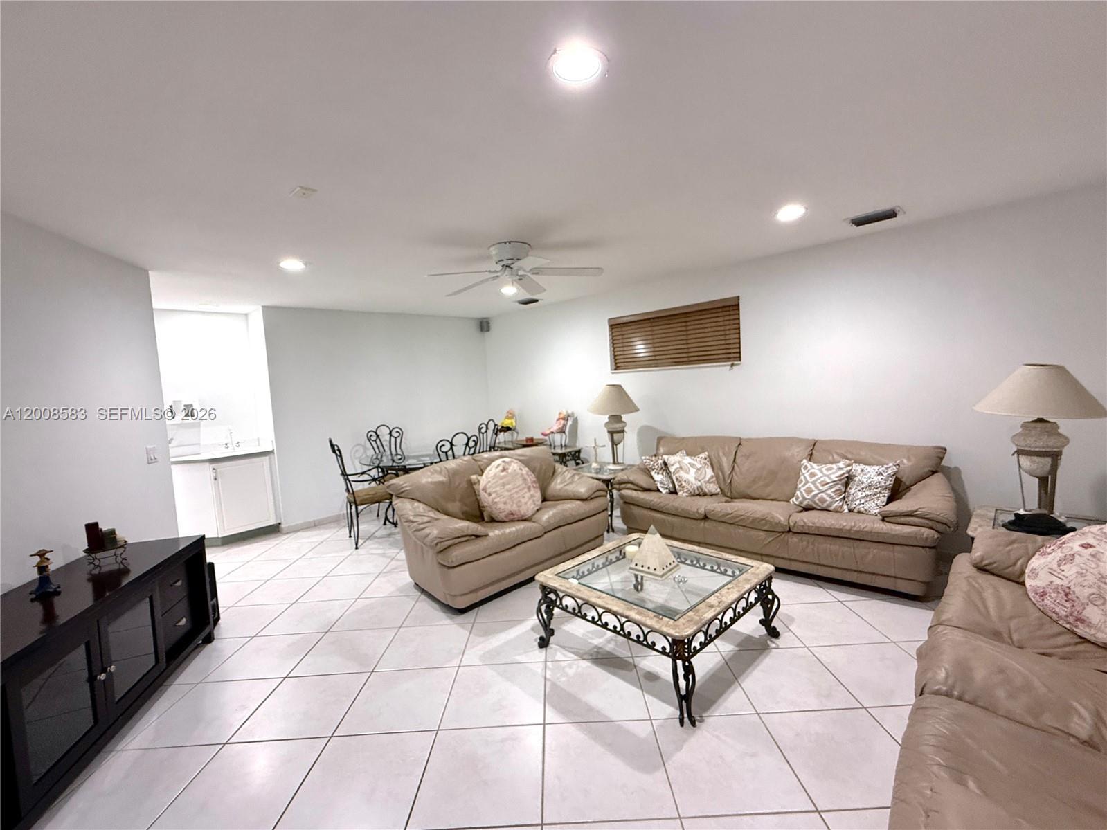 13431 Southwest 32nd Street Miami, FL 33165 - Photo 18 of 77 a living room with furniture and a flat screen tv