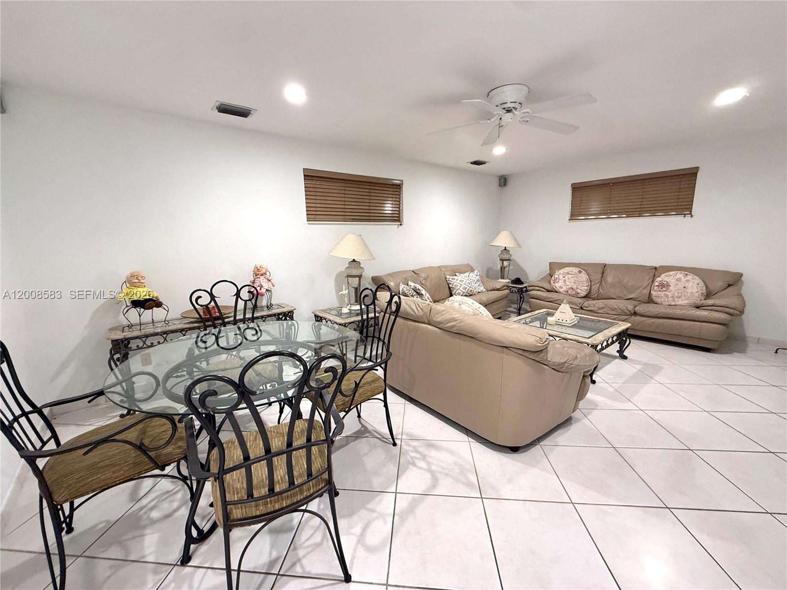 13431 Southwest 32nd Street Miami, FL 33165 - Photo 20 of 77 a living room with furniture and a chandelier