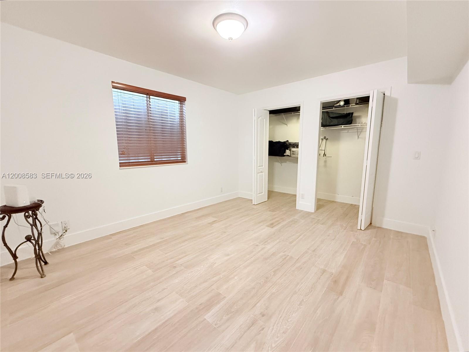 13431 Southwest 32nd Street Miami, FL 33165 - Photo 22 of 77 a view of an empty room with wooden floor and a window