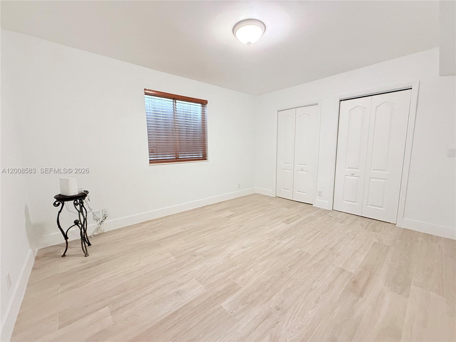 13431 Southwest 32nd Street Miami, FL 33165 - Photo 23 of 77 a view of empty room with wooden floor and fan