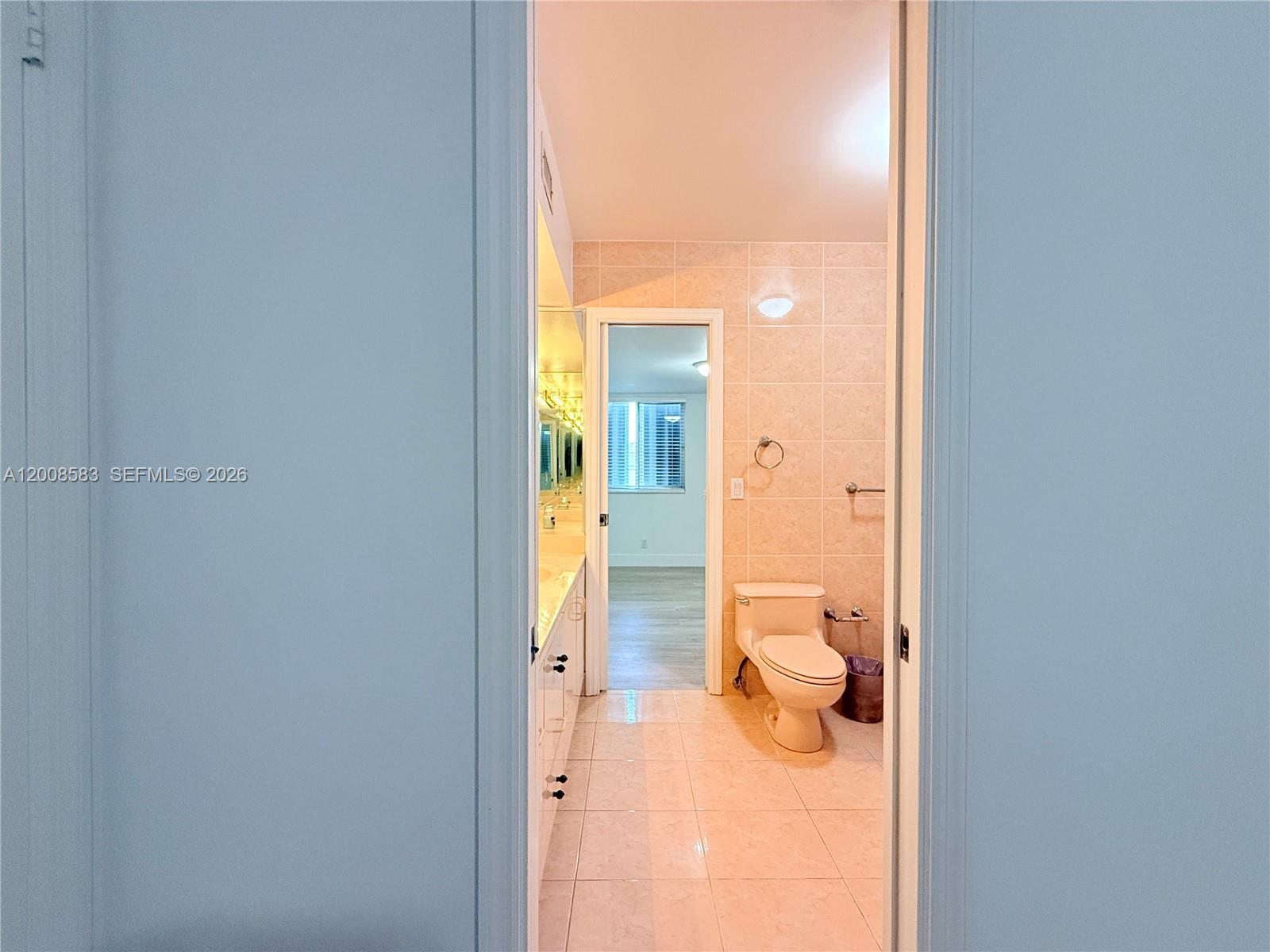 13431 Southwest 32nd Street Miami, FL 33165 - Photo 29 of 77 a bathroom with a glass shower door and a toilet
