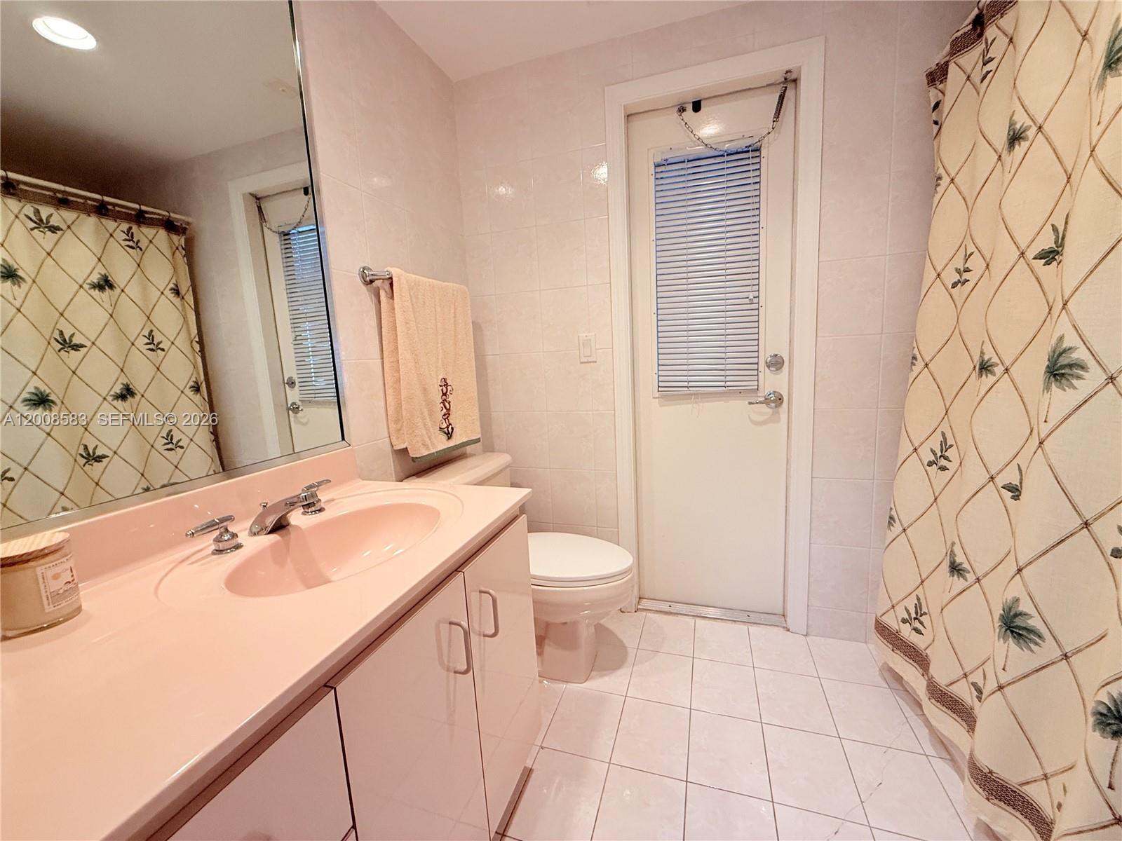 13431 Southwest 32nd Street Miami, FL 33165 - Photo 33 of 77 a bathroom with a sink and a mirror