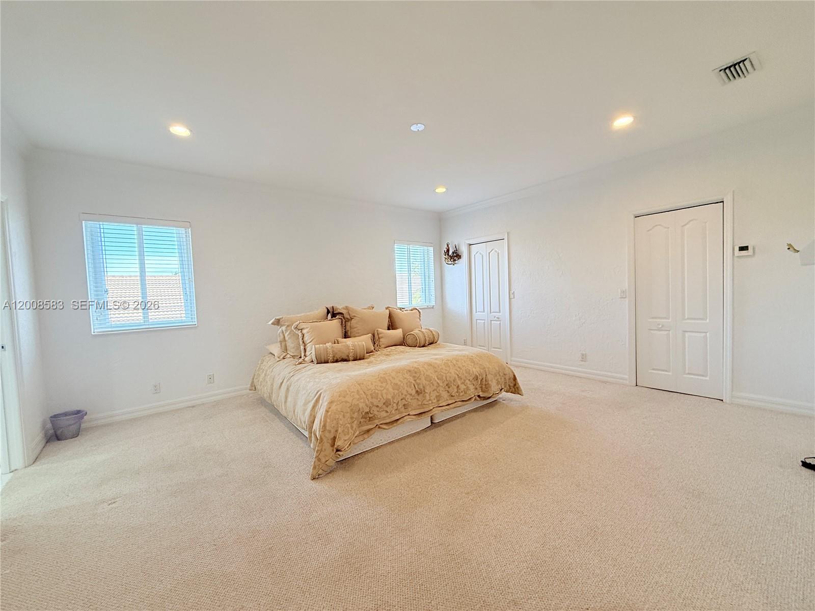 13431 Southwest 32nd Street Miami, FL 33165 - Photo 48 of 77 a spacious bedroom with a bed and a window