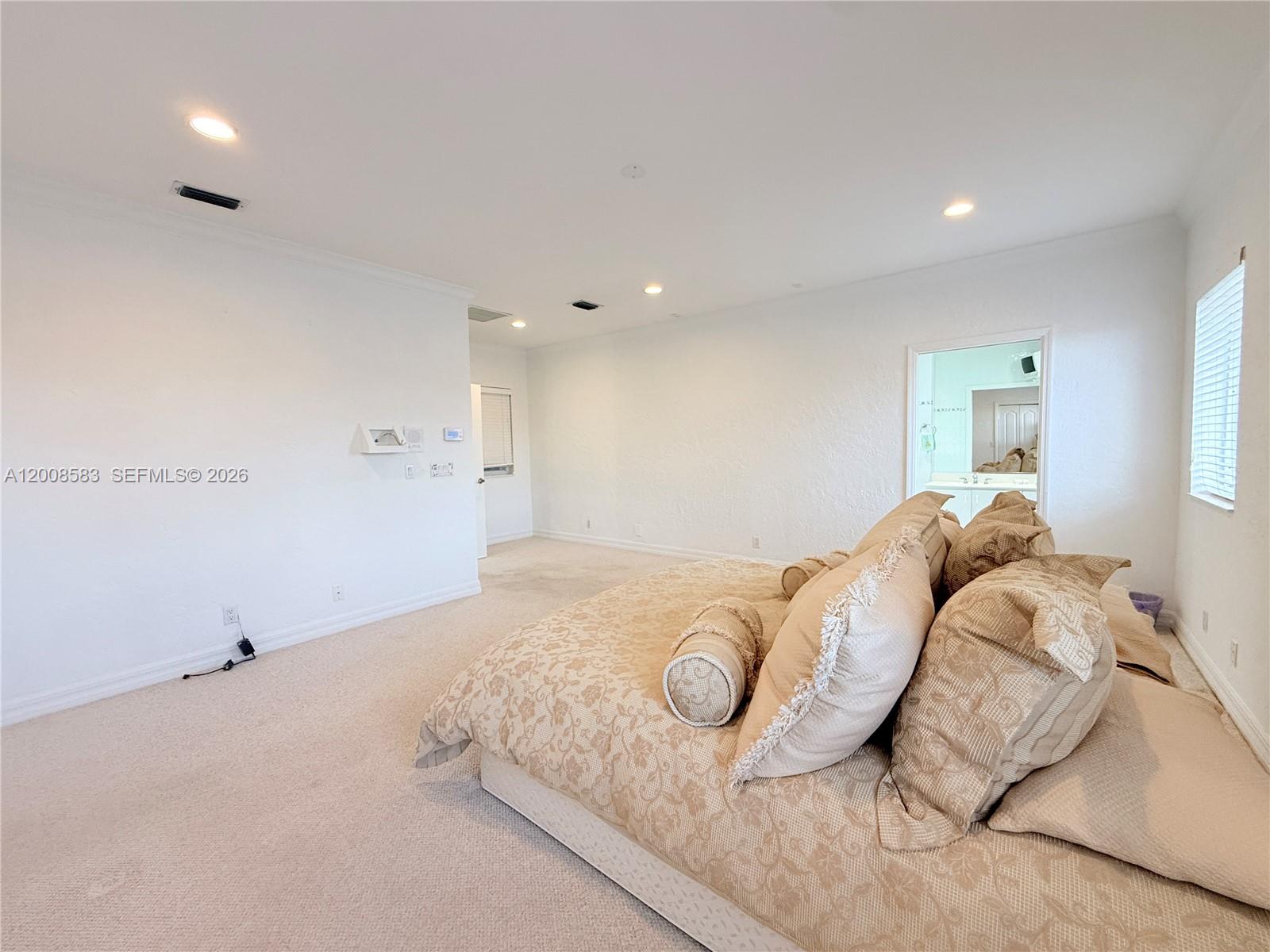 13431 Southwest 32nd Street Miami, FL 33165 - Photo 50 of 77 a bedroom with a bed and a night stand