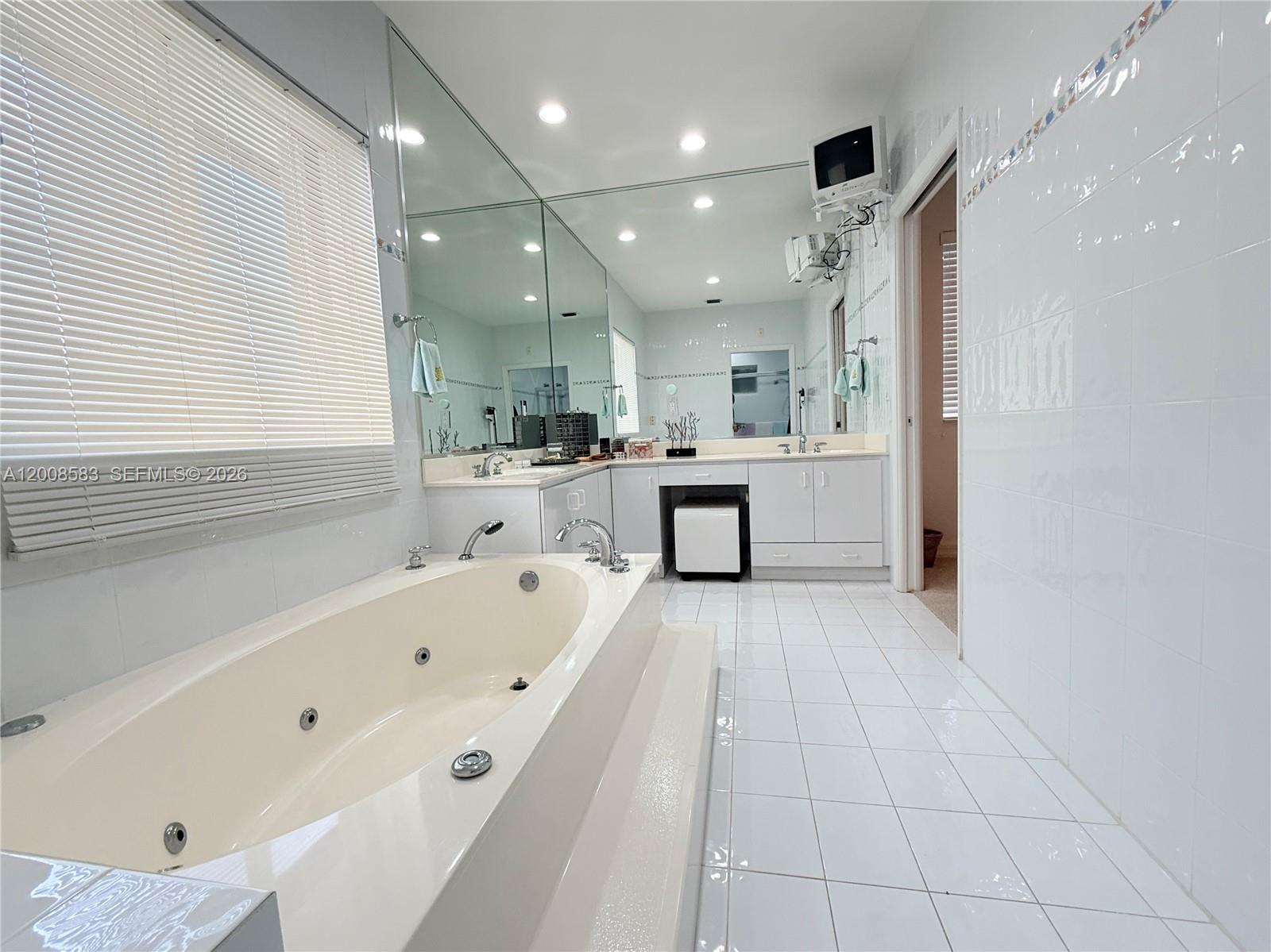 13431 Southwest 32nd Street Miami, FL 33165 - Photo 55 of 77 a large white kitchen with a large window stainless steel appliances and a counter top space