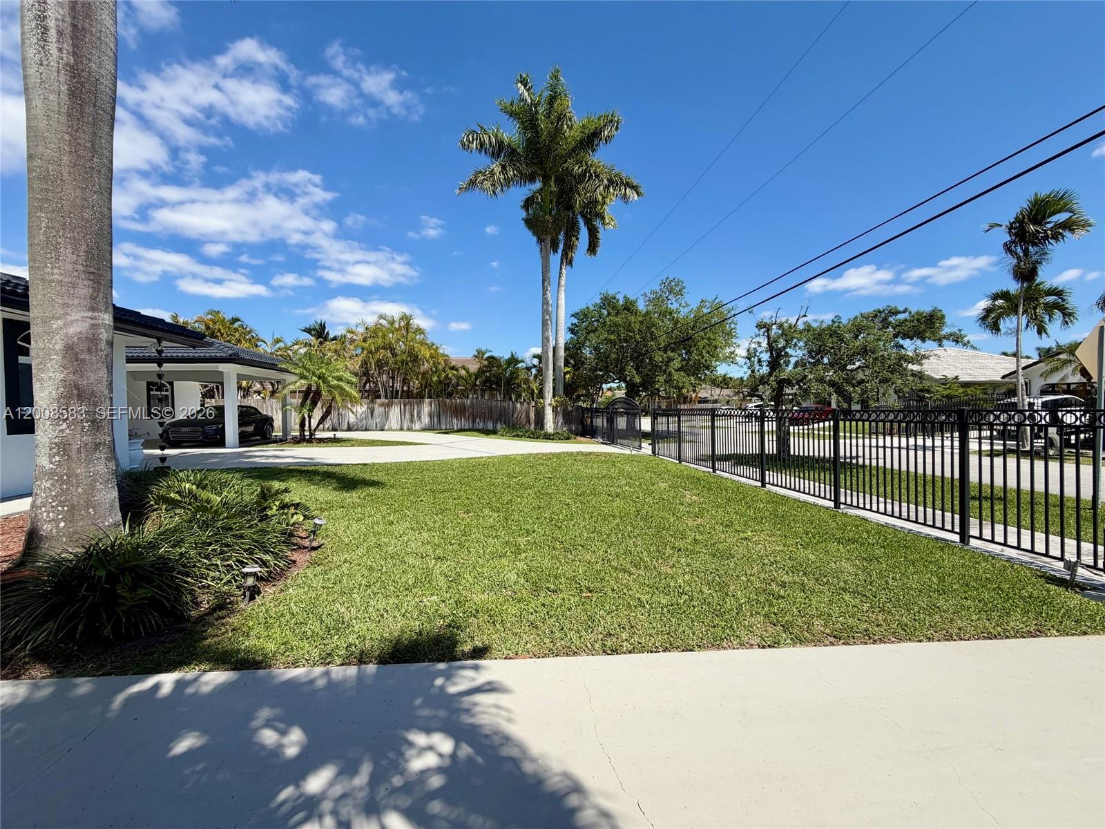 13431 Southwest 32nd Street Miami, FL 33165 - Photo 60 of 77 a view of a garden with a tree in the background