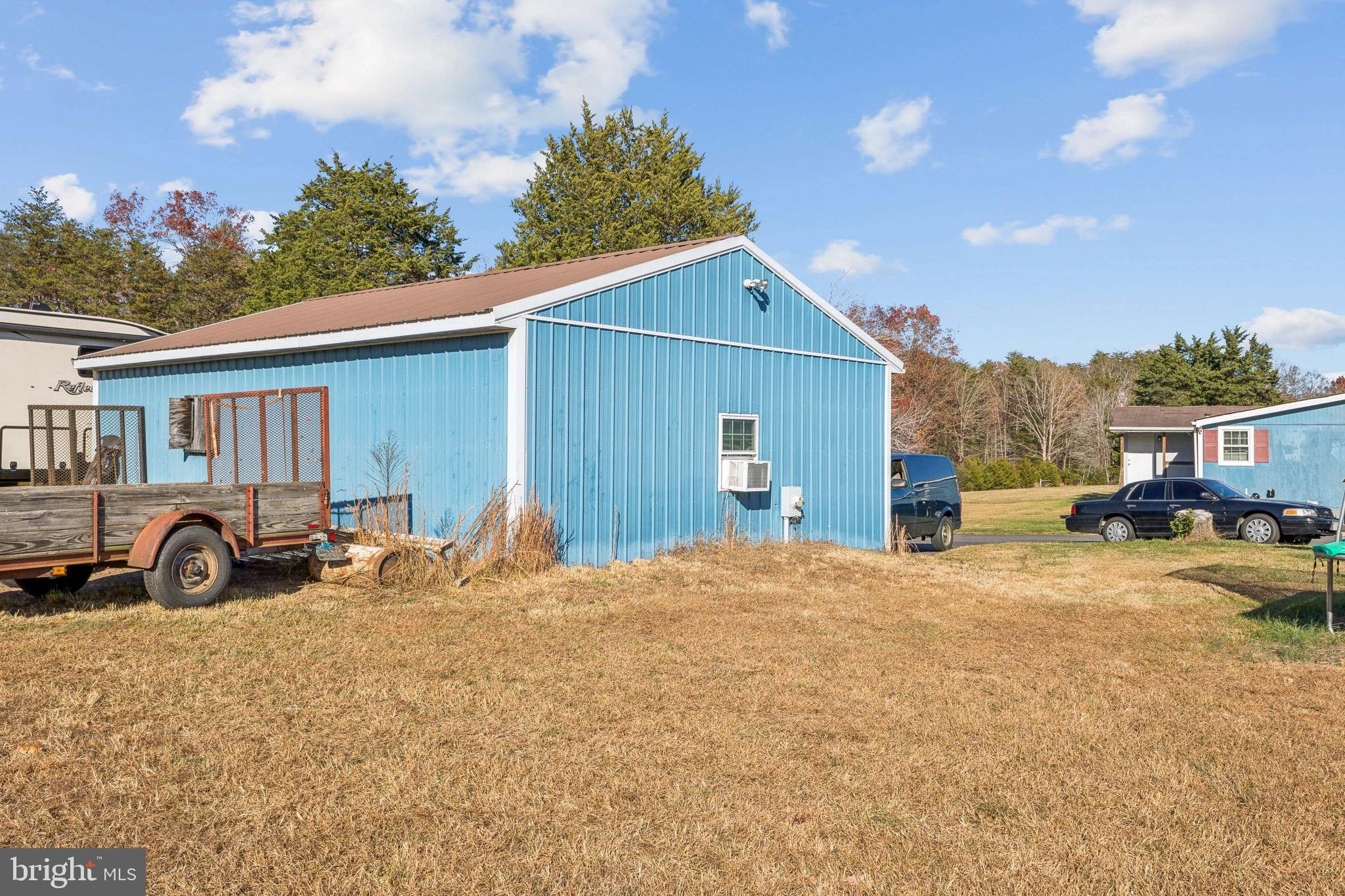 10237 Hook Road Rapidan, VA 22733 - Photo 14 of 37 a view of a house with a patio and a yard