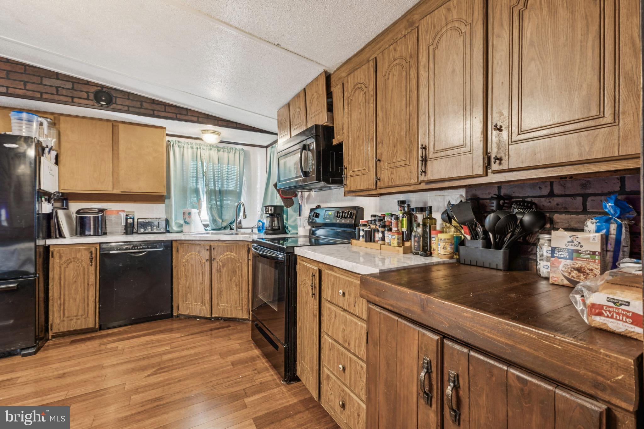 10237 Hook Road Rapidan, VA 22733 - Photo 18 of 37 a kitchen with stainless steel appliances granite countertop a sink a stove and cabinets