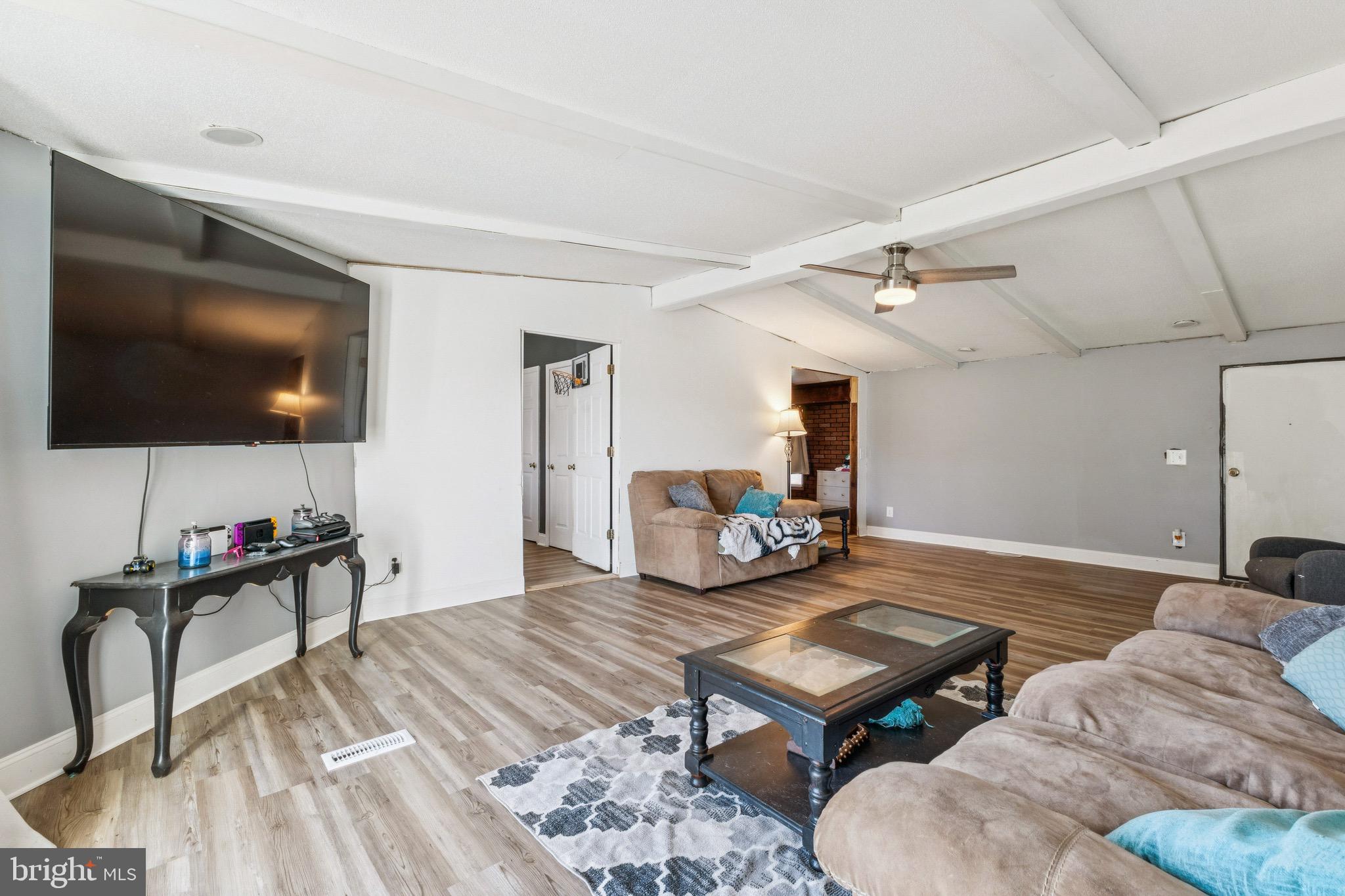 10237 Hook Road Rapidan, VA 22733 - Photo 25 of 37 a living room with furniture a flat screen tv and kitchen view