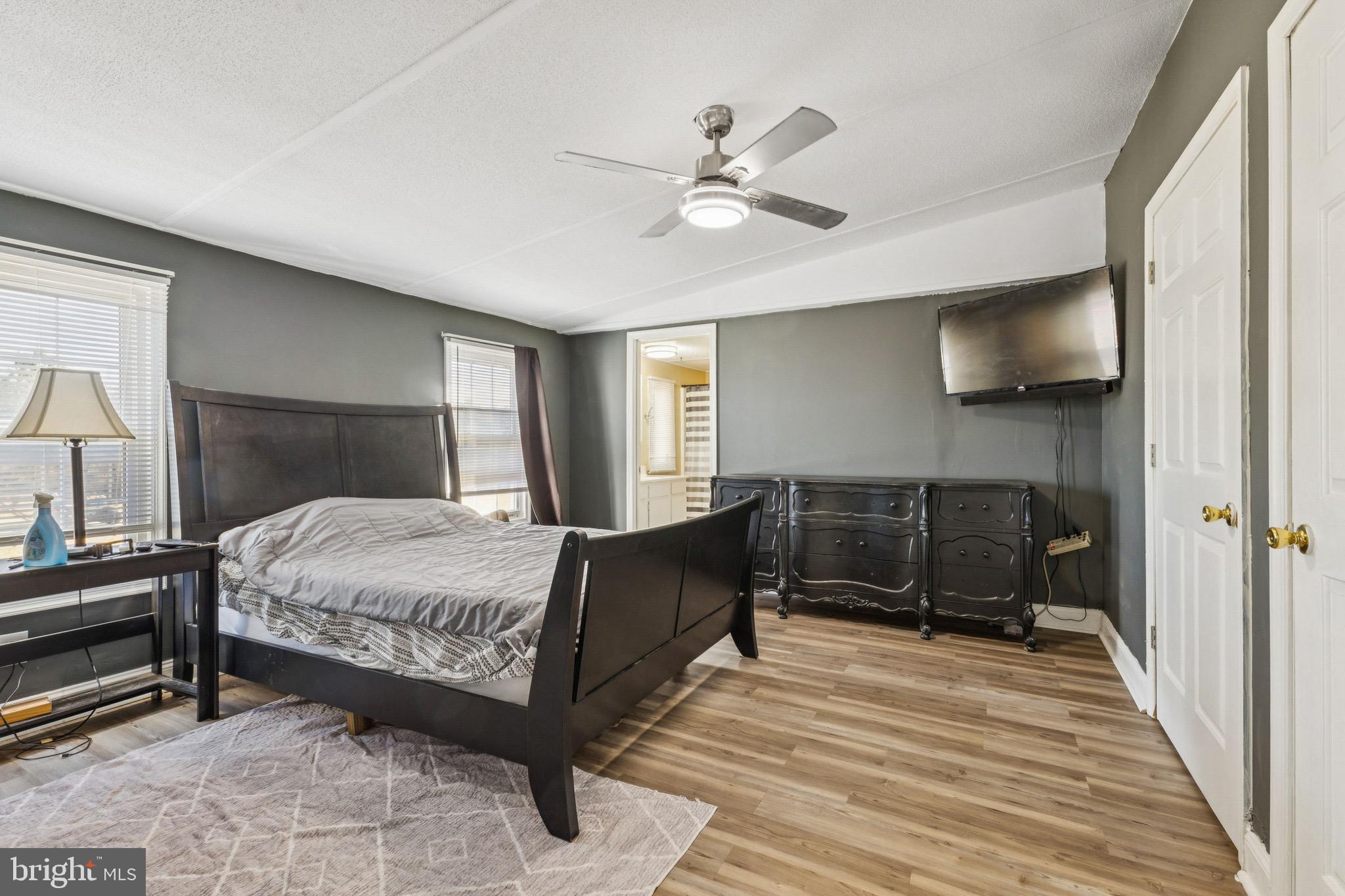 10237 Hook Road Rapidan, VA 22733 - Photo 28 of 37 a bedroom with a bed and a chandelier