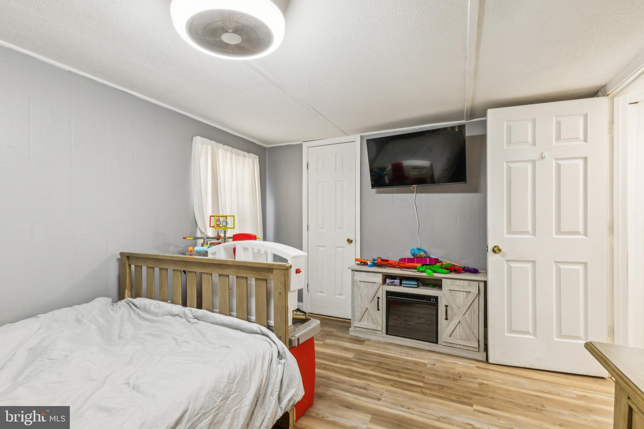 10237 Hook Road Rapidan, VA 22733 - Photo 34 of 37 a bedroom with a bed a flat screen tv and a window