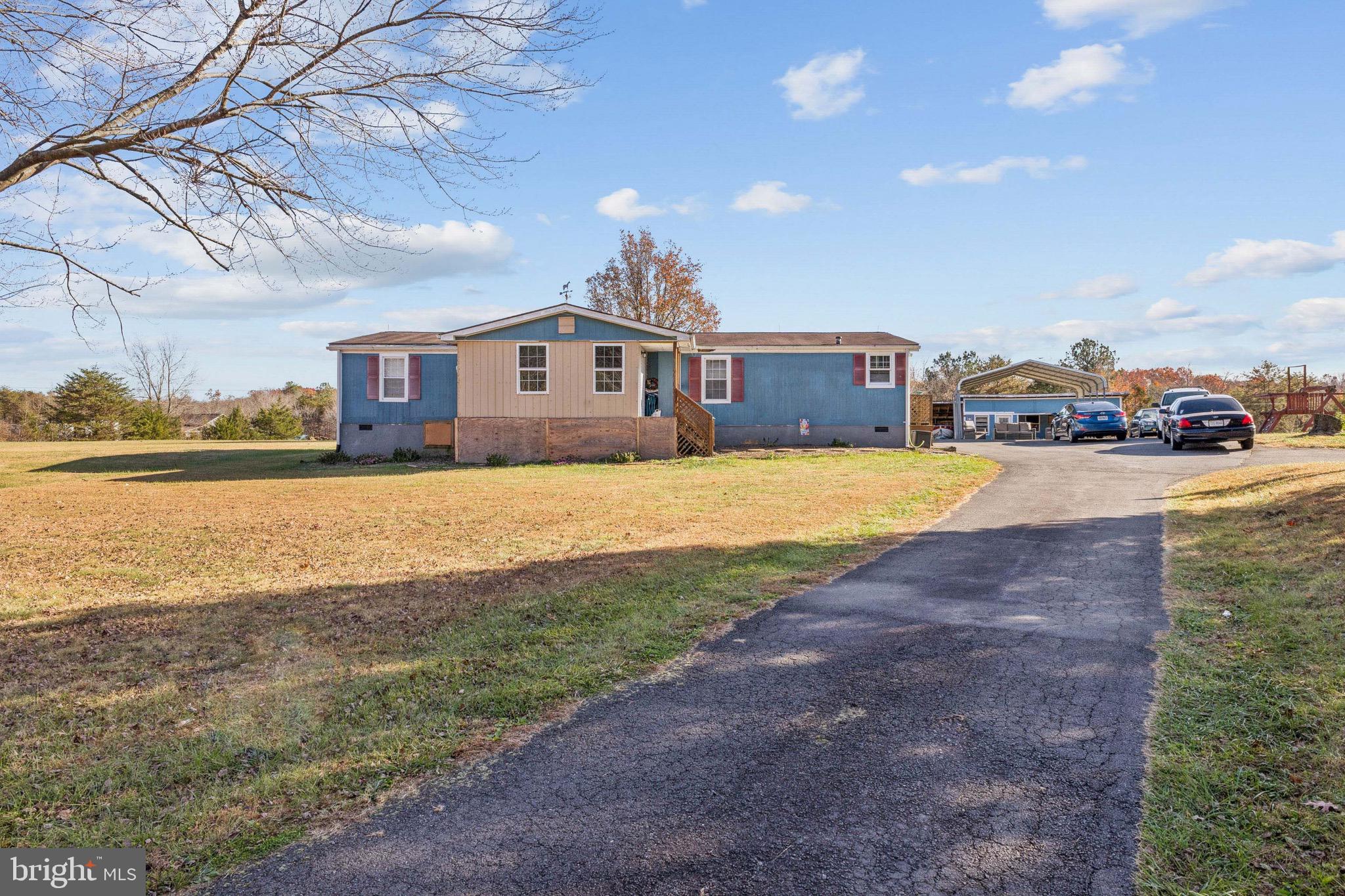 10237 Hook Road Rapidan, VA 22733 - Photo 4 of 37 a front view of a house with a yard and ocean view