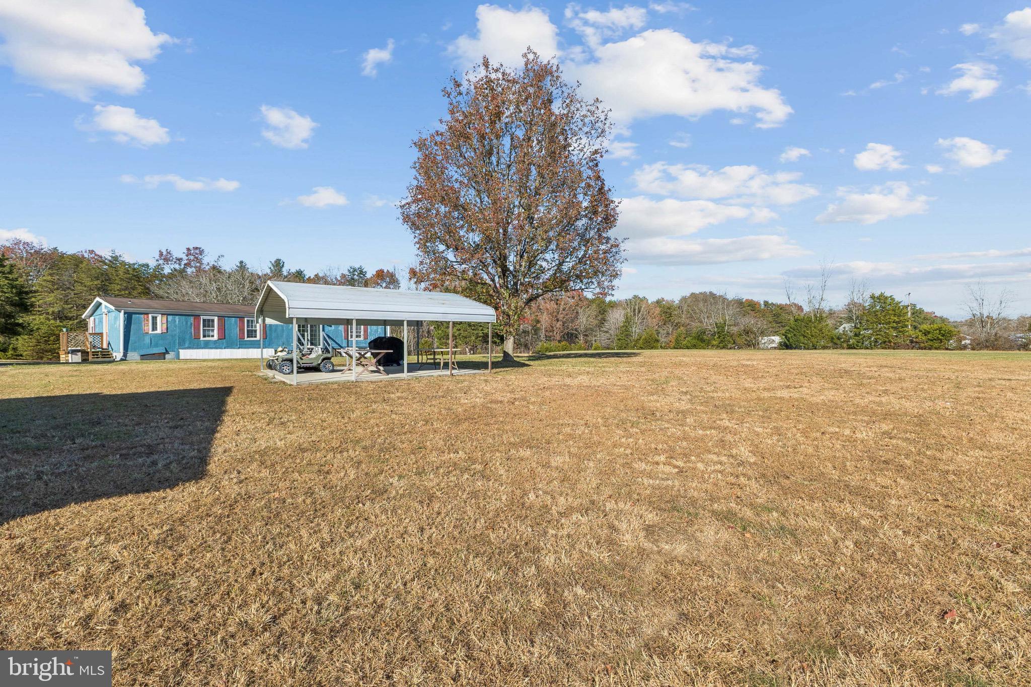 10237 Hook Road Rapidan, VA 22733 - Photo 10 of 37 a front view of a house with a yard and lake