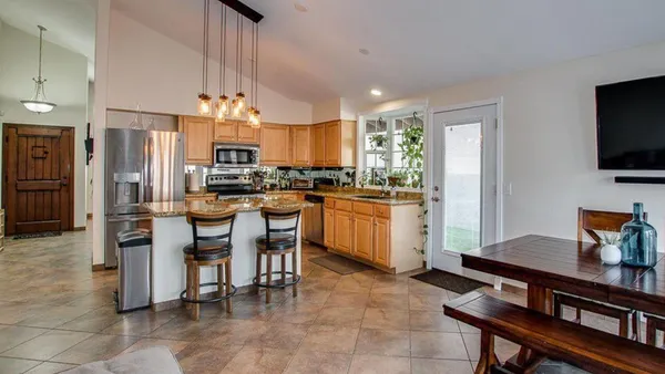 a kitchen with a sink a counter top space appliances and cabinets
