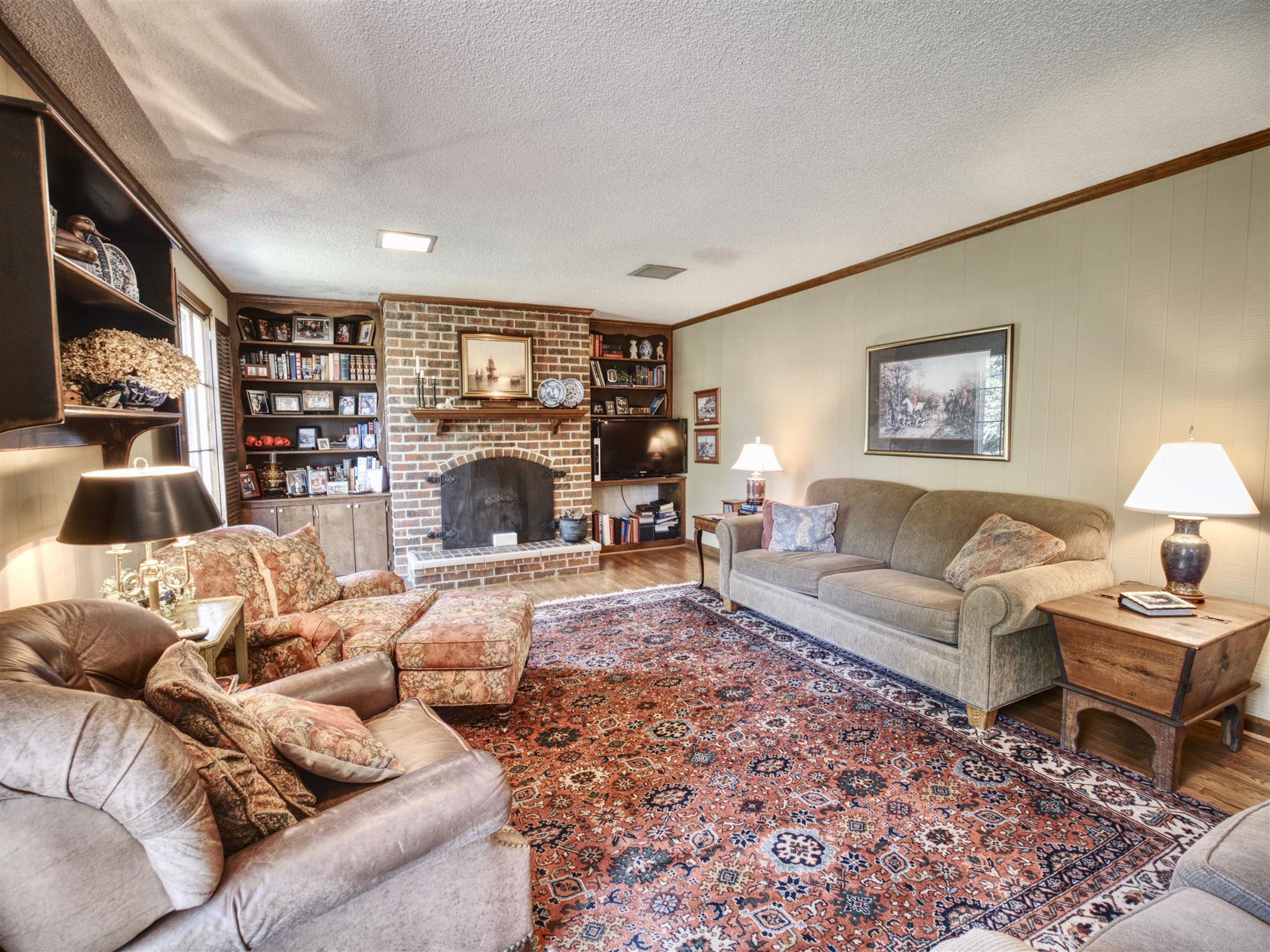 1802 Indian Hills Road Lebanon, TN 37087 - Photo 13 of 29 Cozy fireplace and built-ins with hardwood floors