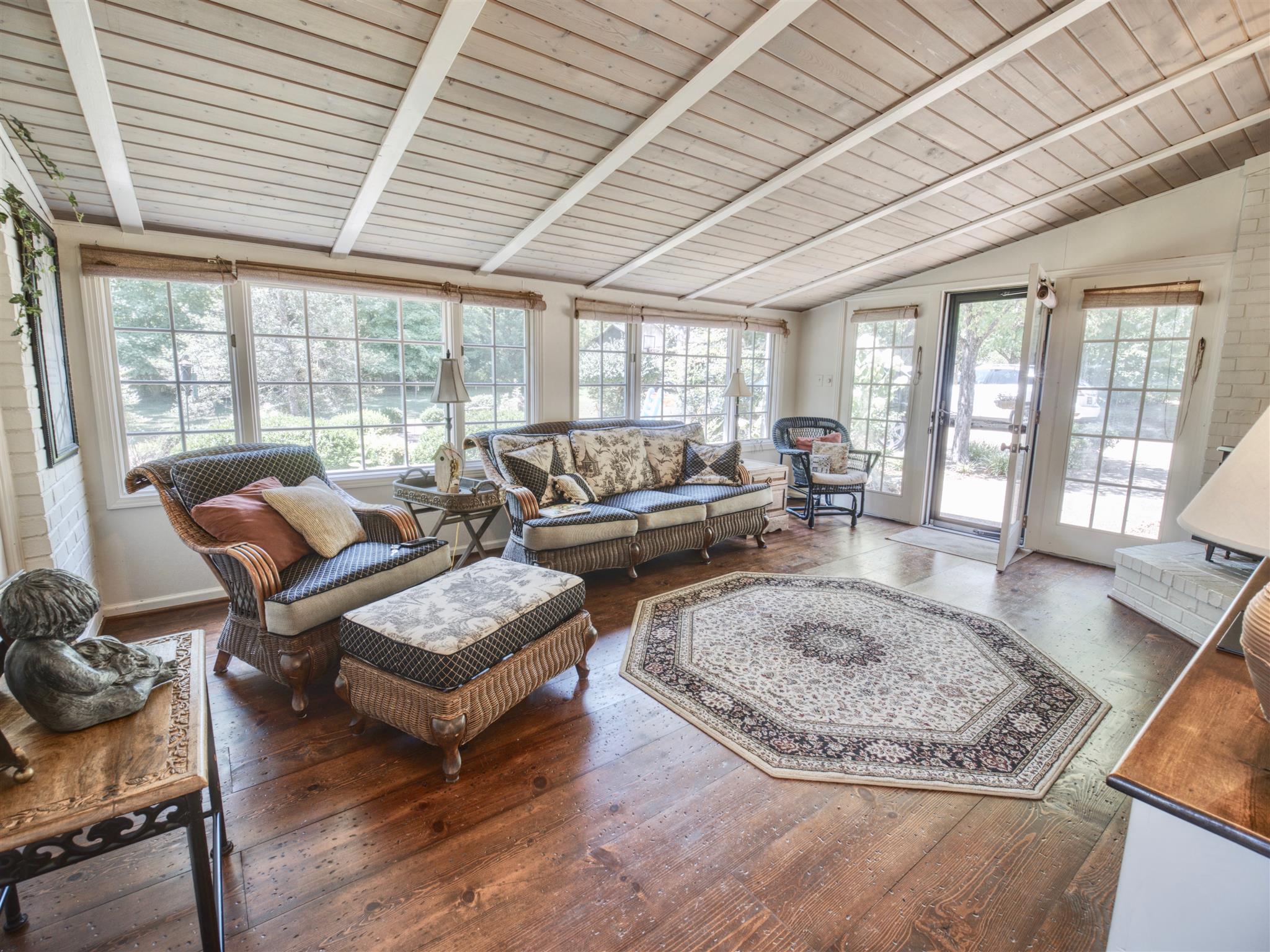 1802 Indian Hills Road Lebanon, TN 37087 - Photo 15 of 29 Den has lots of windows with distressed pine floors, painted brick and headboard ceiling