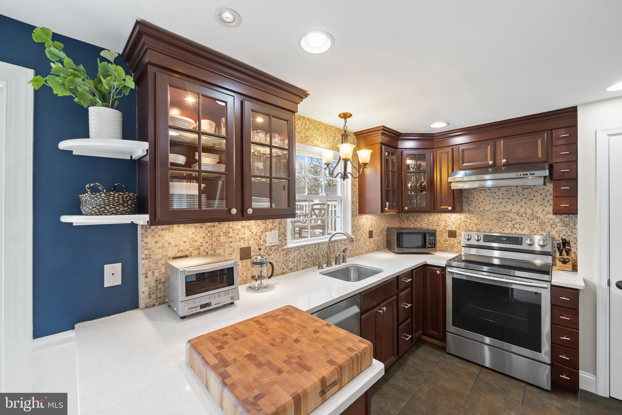 412 Iven Avenue Wayne, PA 19087 - Photo 9 of 26 a kitchen with stainless steel appliances granite countertop a stove a sink and a refrigerator