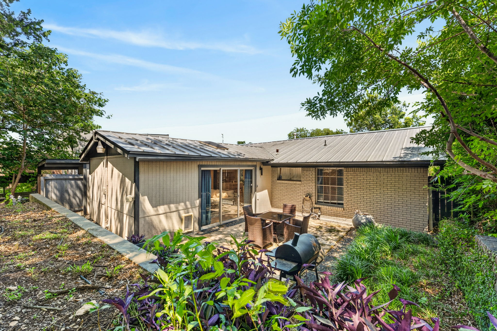 3604 Wilson Street Austin, TX 78704 - Photo 24 of 25 a backyard of a house with table and chairs