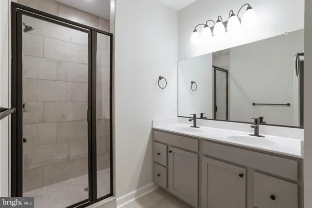 a bathroom with a double vanity sink mirror and