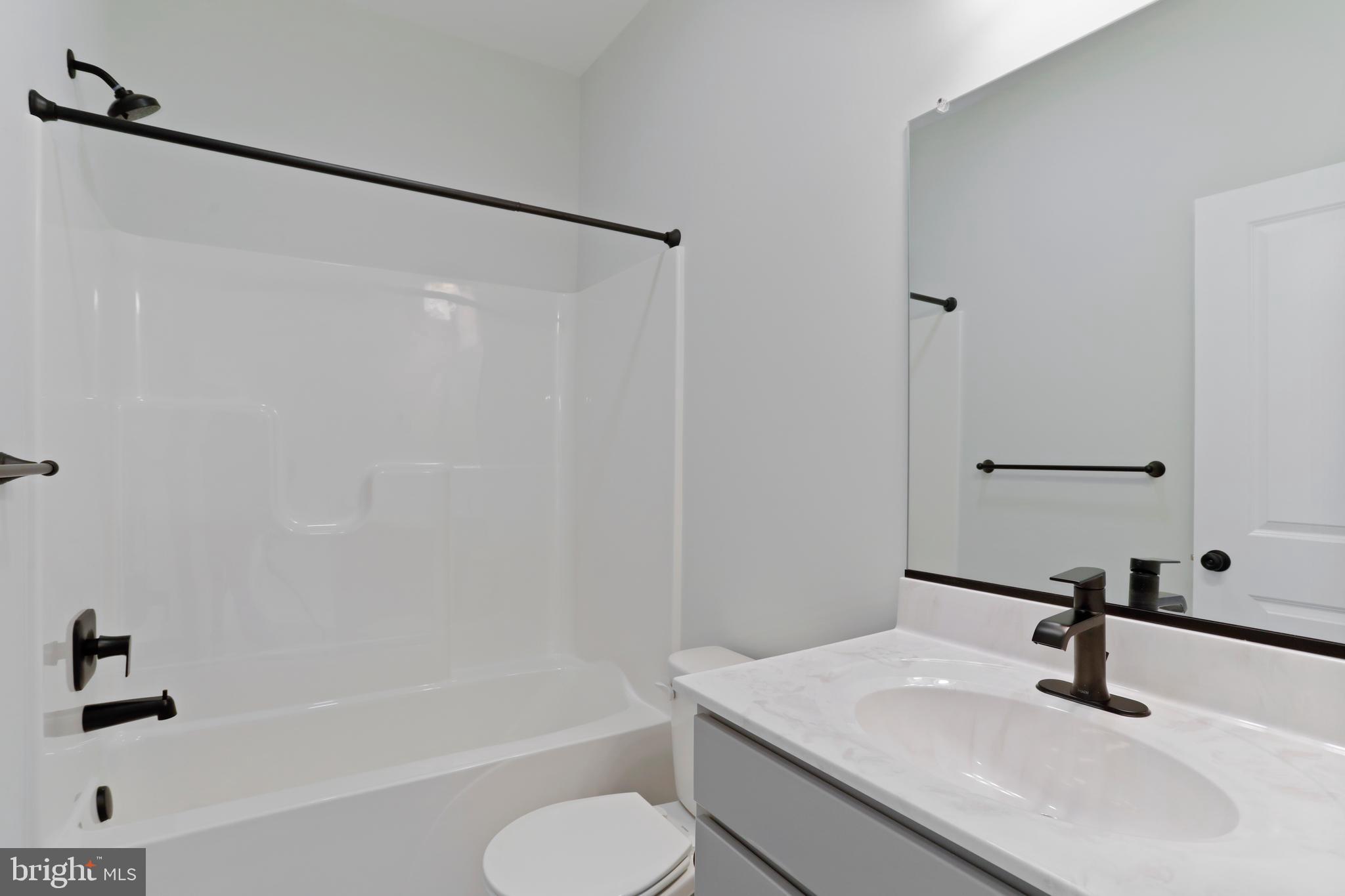 32 Larimar Lane Inwood, WV 25428 - Photo 24 of 28 a bathroom with a sink toilet and shower