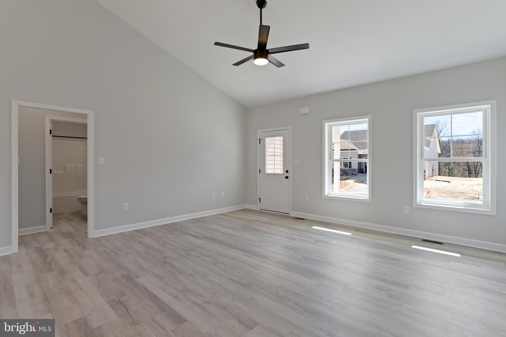 32 Larimar Lane Inwood, WV 25428 - Photo 5 of 28 a view of an empty room with a window and wooden floor