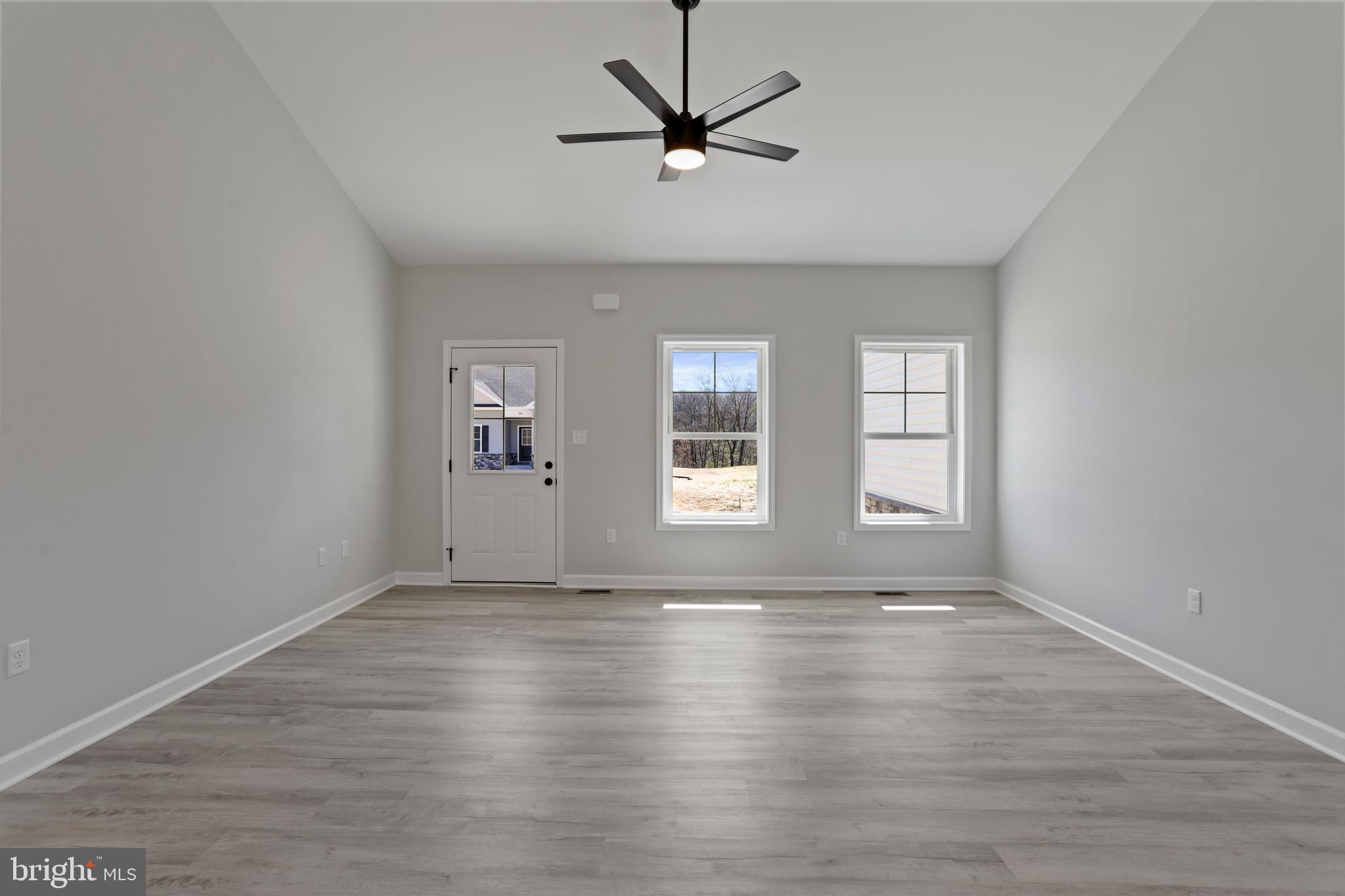 32 Larimar Lane Inwood, WV 25428 - Photo 7 of 28 a view of an empty room with window and wooden floor
