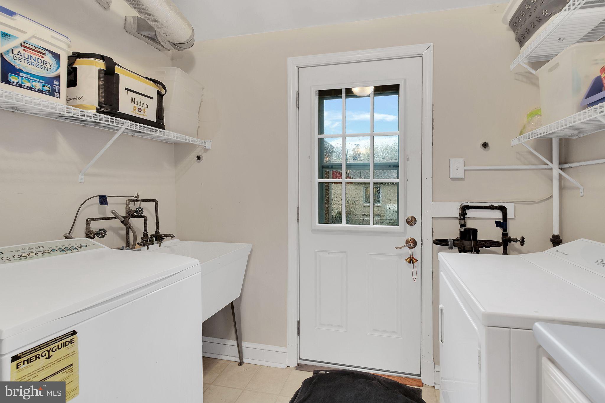 2204 Prichard Road Silver Spring, MD 20902 - Photo 12 of 26 a utility room with dryer washer and a view of living room