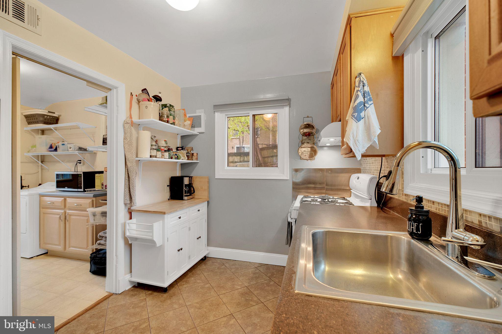 2204 Prichard Road Silver Spring, MD 20902 - Photo 10 of 26 a kitchen with white cabinets and sink